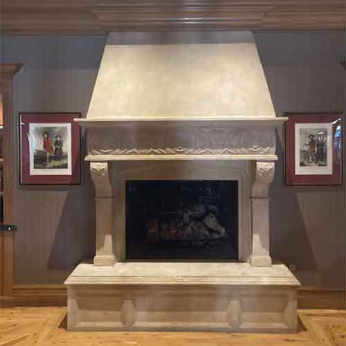 Aelite photo of beautiful ornate fireplace with photos on each side and wood flooring